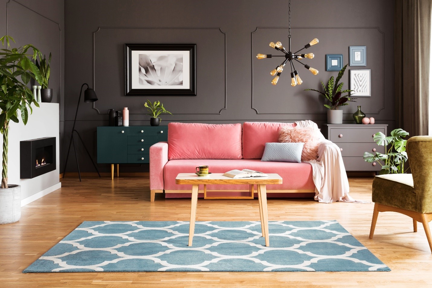 A vibrant pink couch sits in the center of a living room.