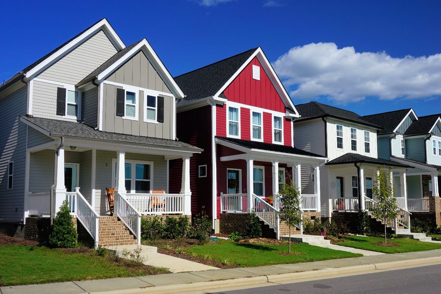 A row of similar single-family homes lining a street.