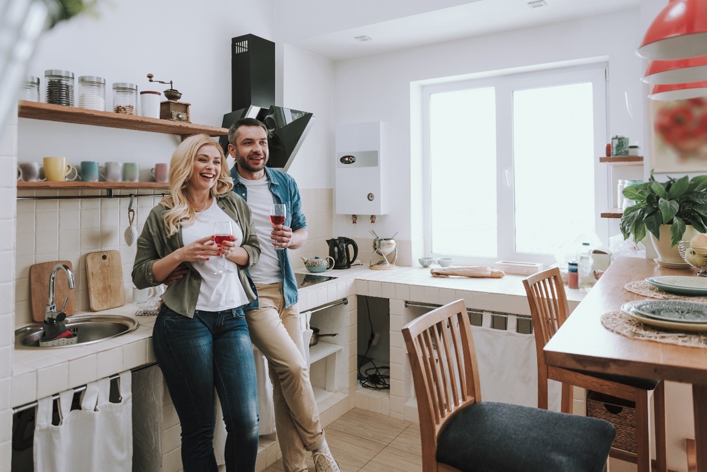 A couple happily relaxing in their newly set up kitchen.