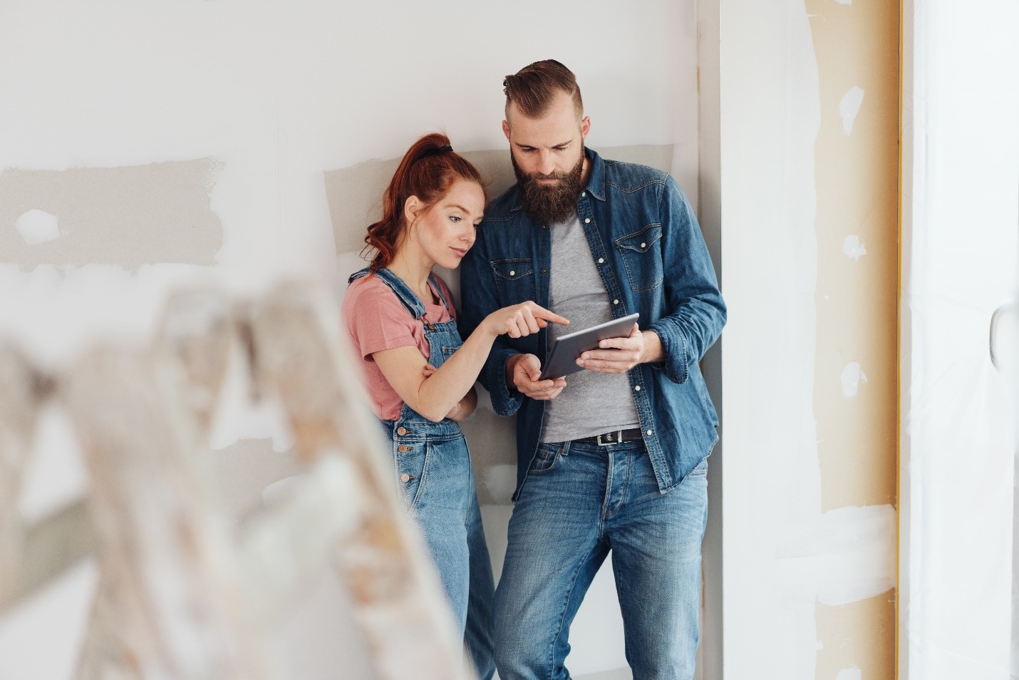 Couple inspecting their new construction home plan.
